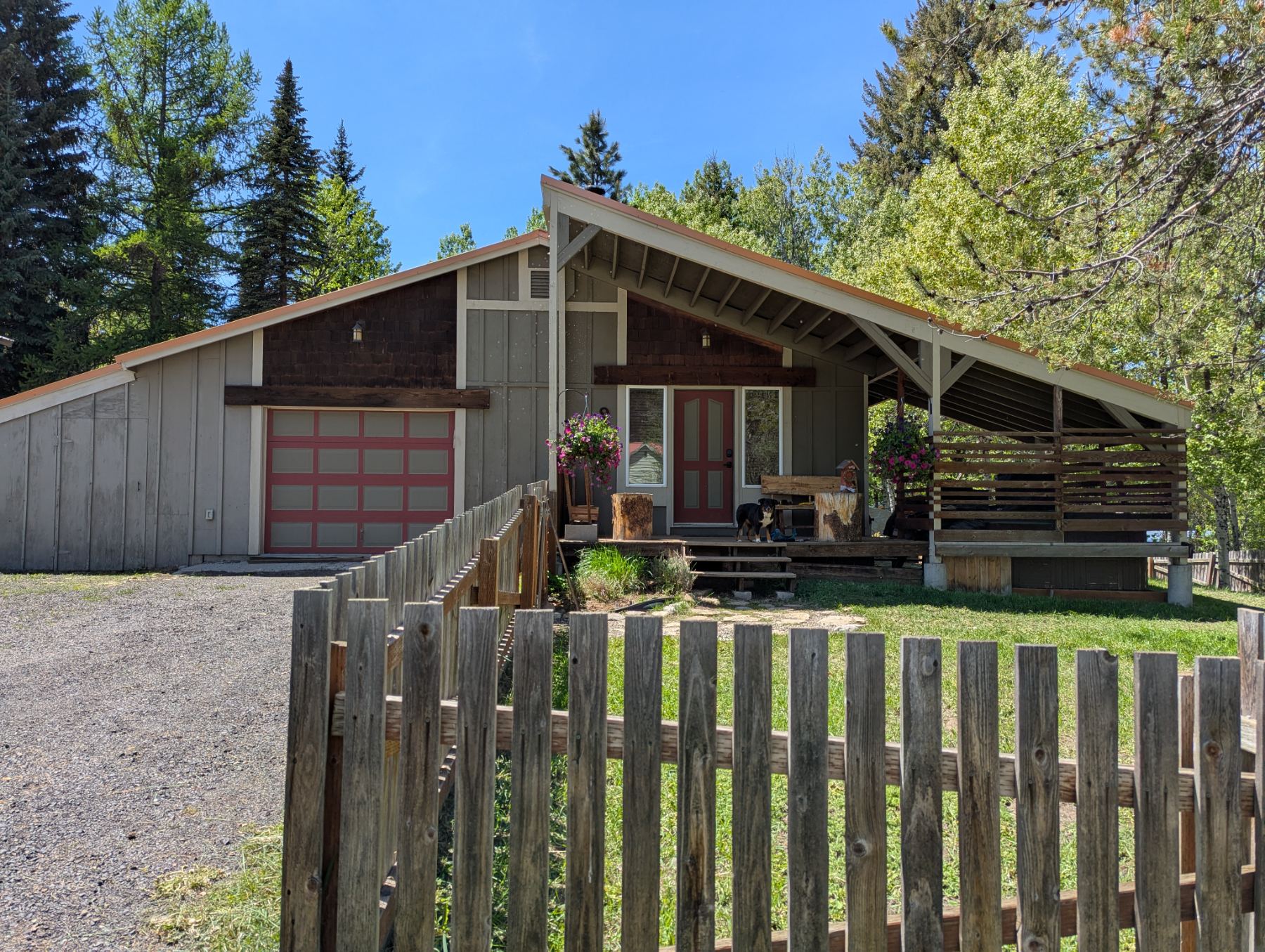 Side view of the house in summer, garage and covered porch